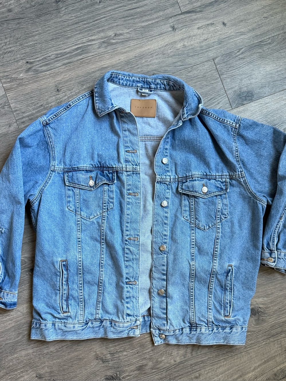 Topshop oversized denim jacket in a classic medium blue wash. Features button fr